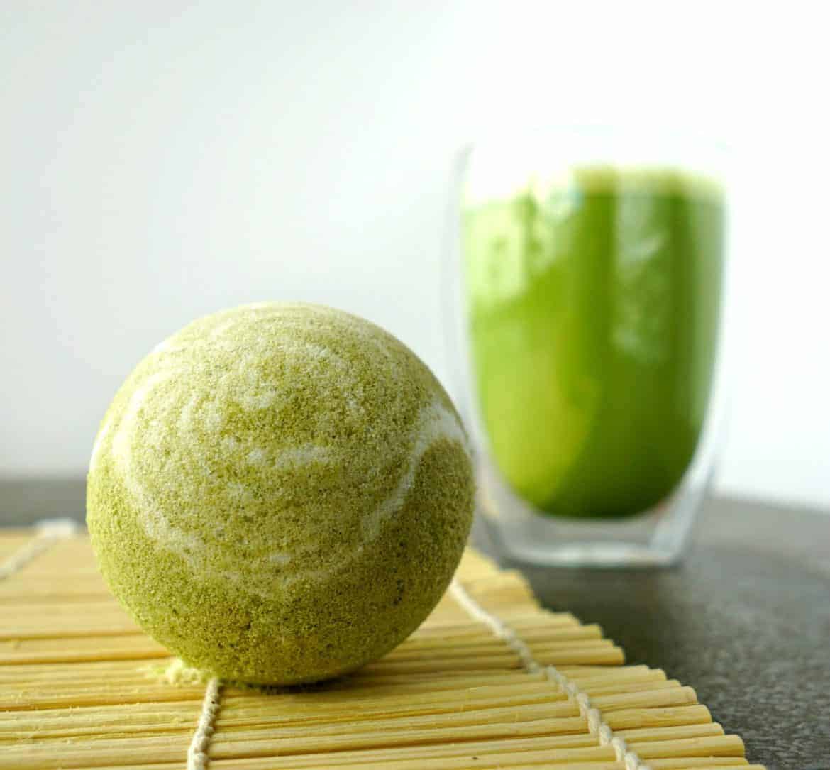 green and white swirled bath bombs with a matcha green drink