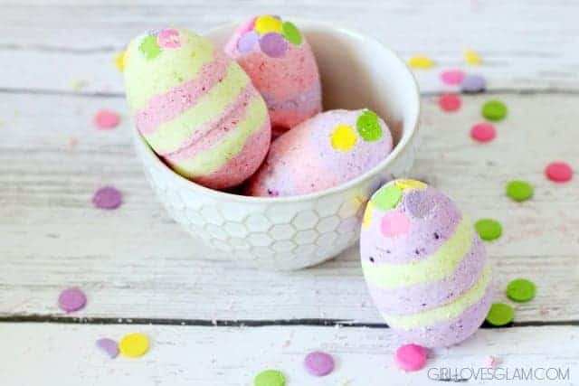 Bath bombs in the shame of Easter eggs with coloured stripes