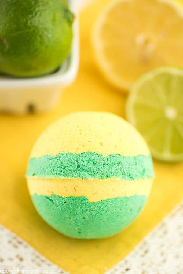 round bath bomb with yellow and green stripes.