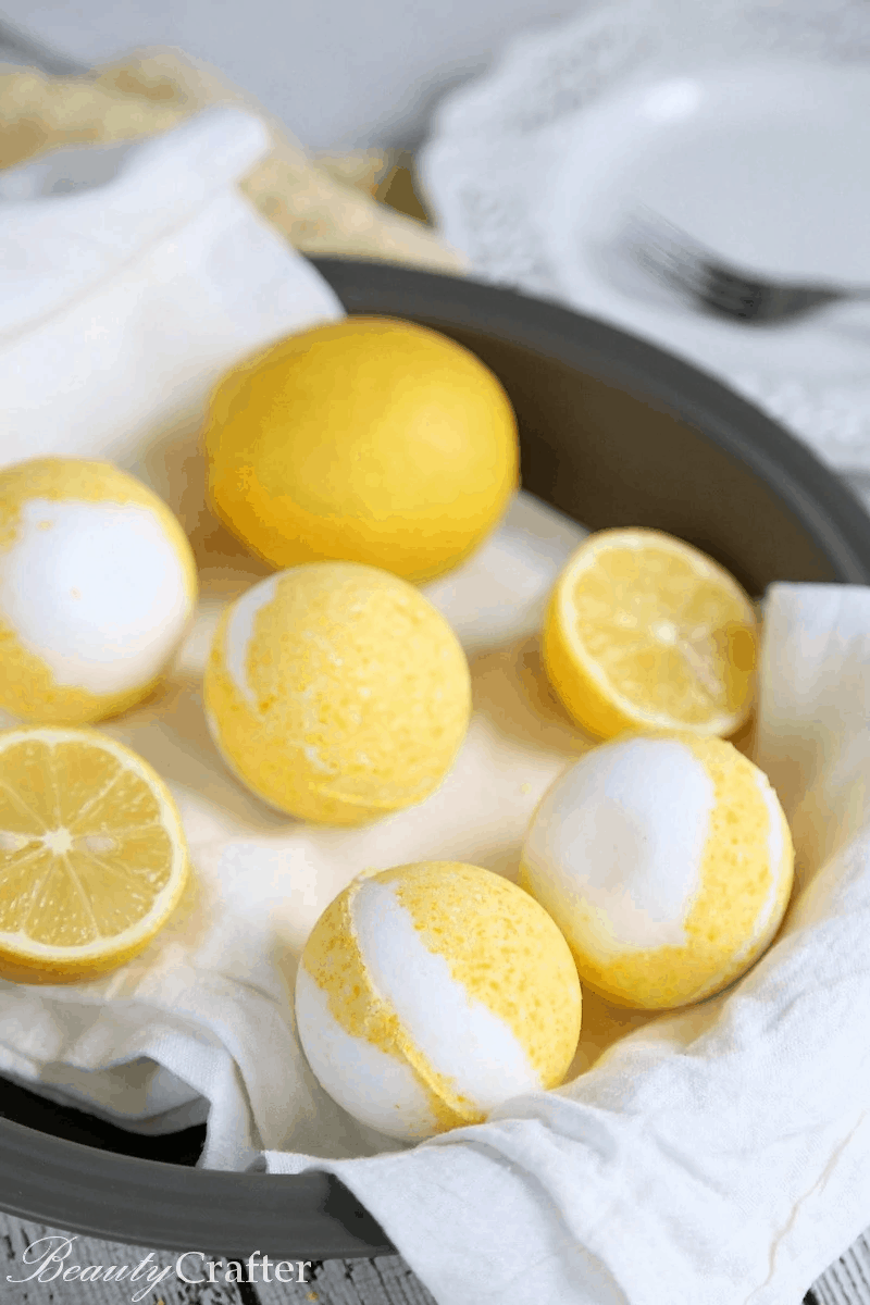 Yellow and white round bath bombs that are lemon meringue pie themed