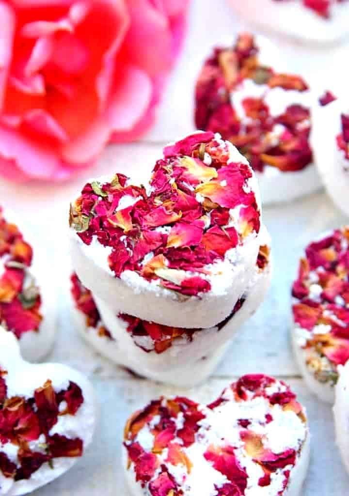 Heart shaped white bath bombs with rose petals crushed on top