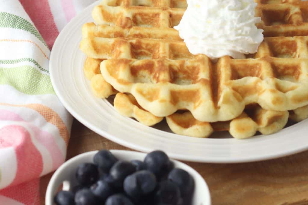 gluten-free belgian waffles with cream and blueberries