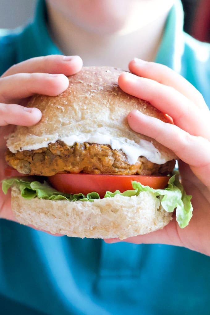 Child holding lentil bruger