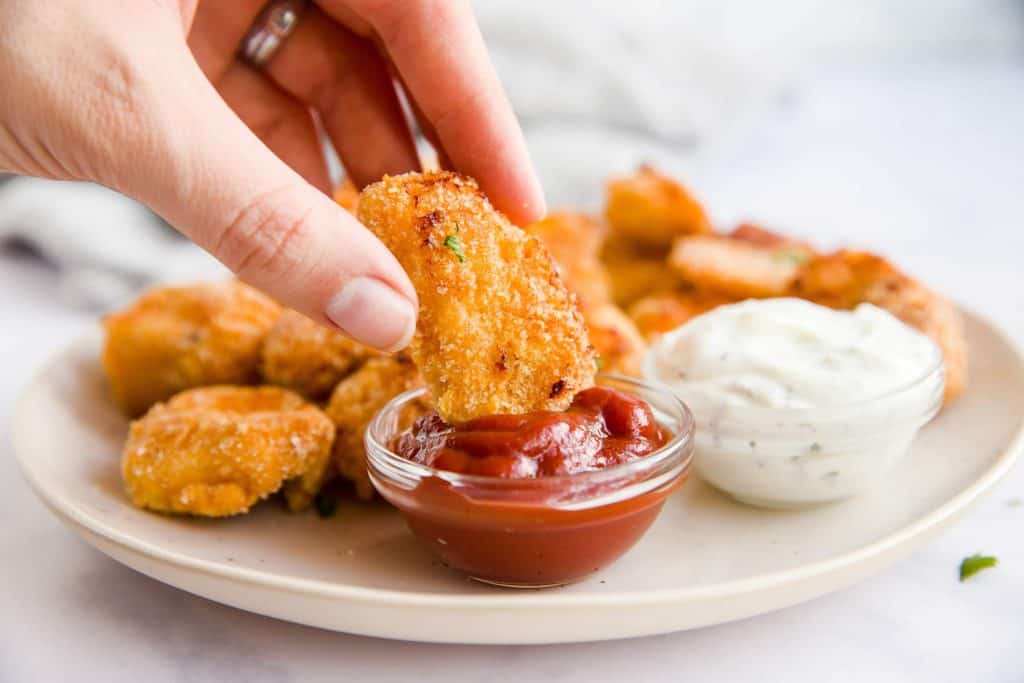 Chicken nuggets dipped in sauce