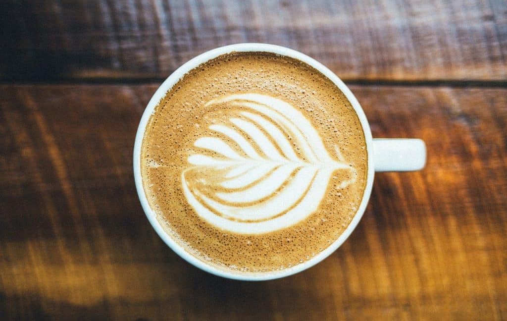 Aerial shot of cappuccino on wooden table