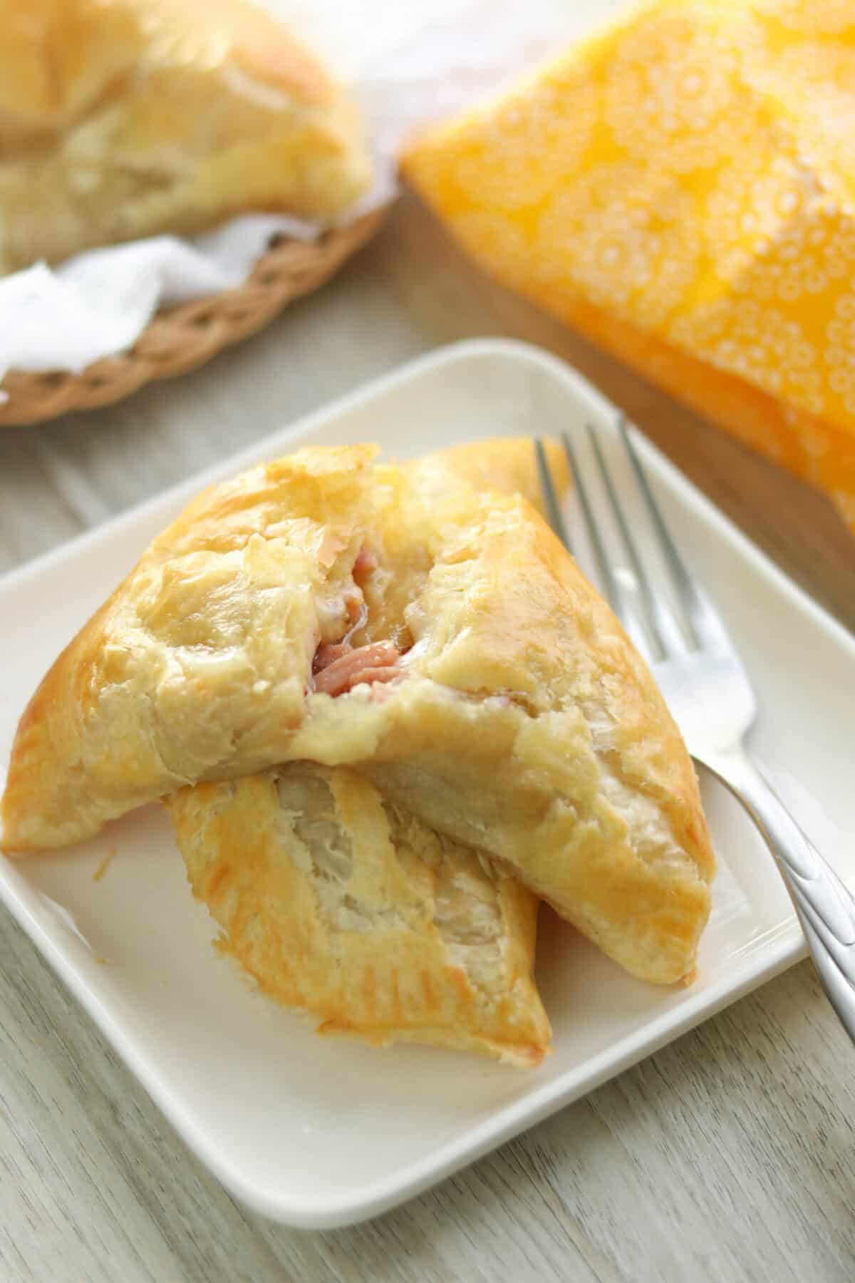 Golden-brown honey mustard ham and Swiss puff pastry handwiches fresh out of the oven.