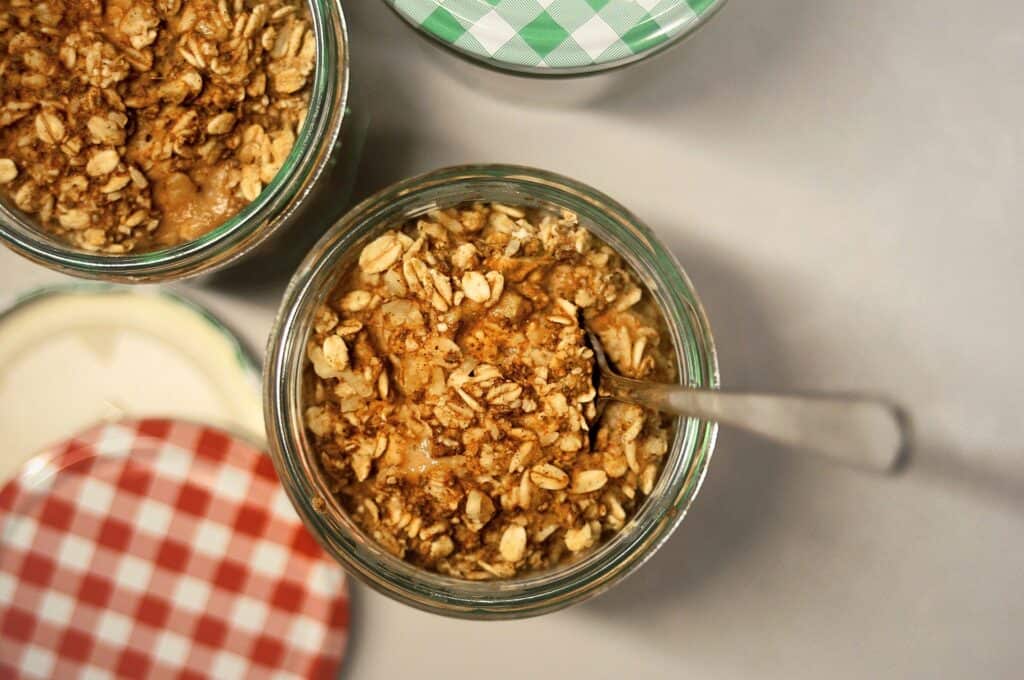 Two jars of baked overnight oats on table