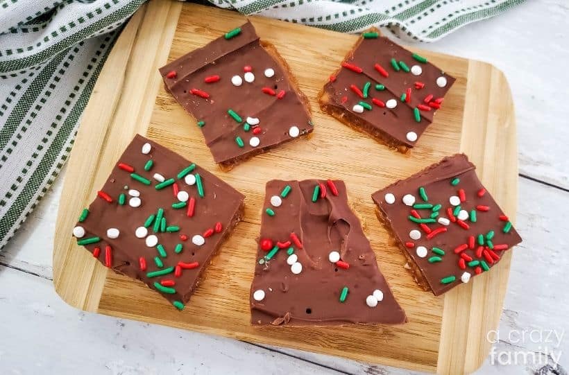 Christmas cracker bark presented on a wooden chopping board.