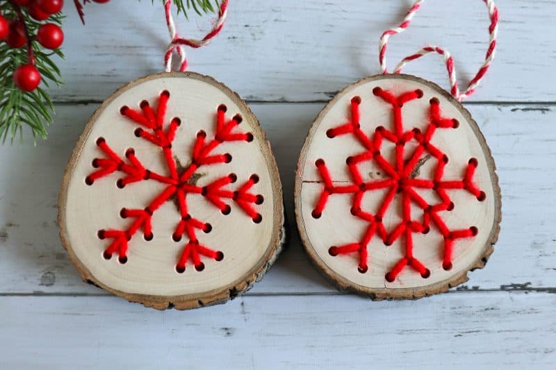 Wooden Snowflake Christmas Ornaments made with yarn.