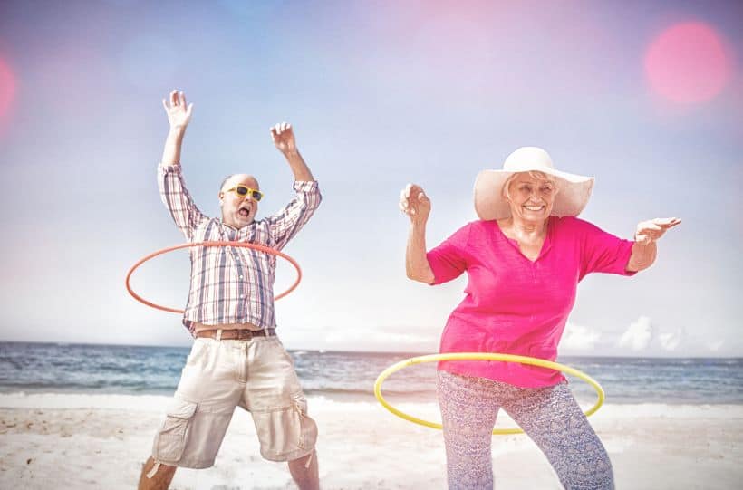 Senior couple doing hula hoop