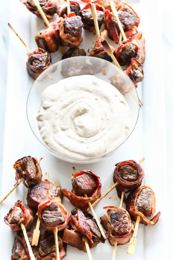 Steak appetizer with bowl of horseradish sauce