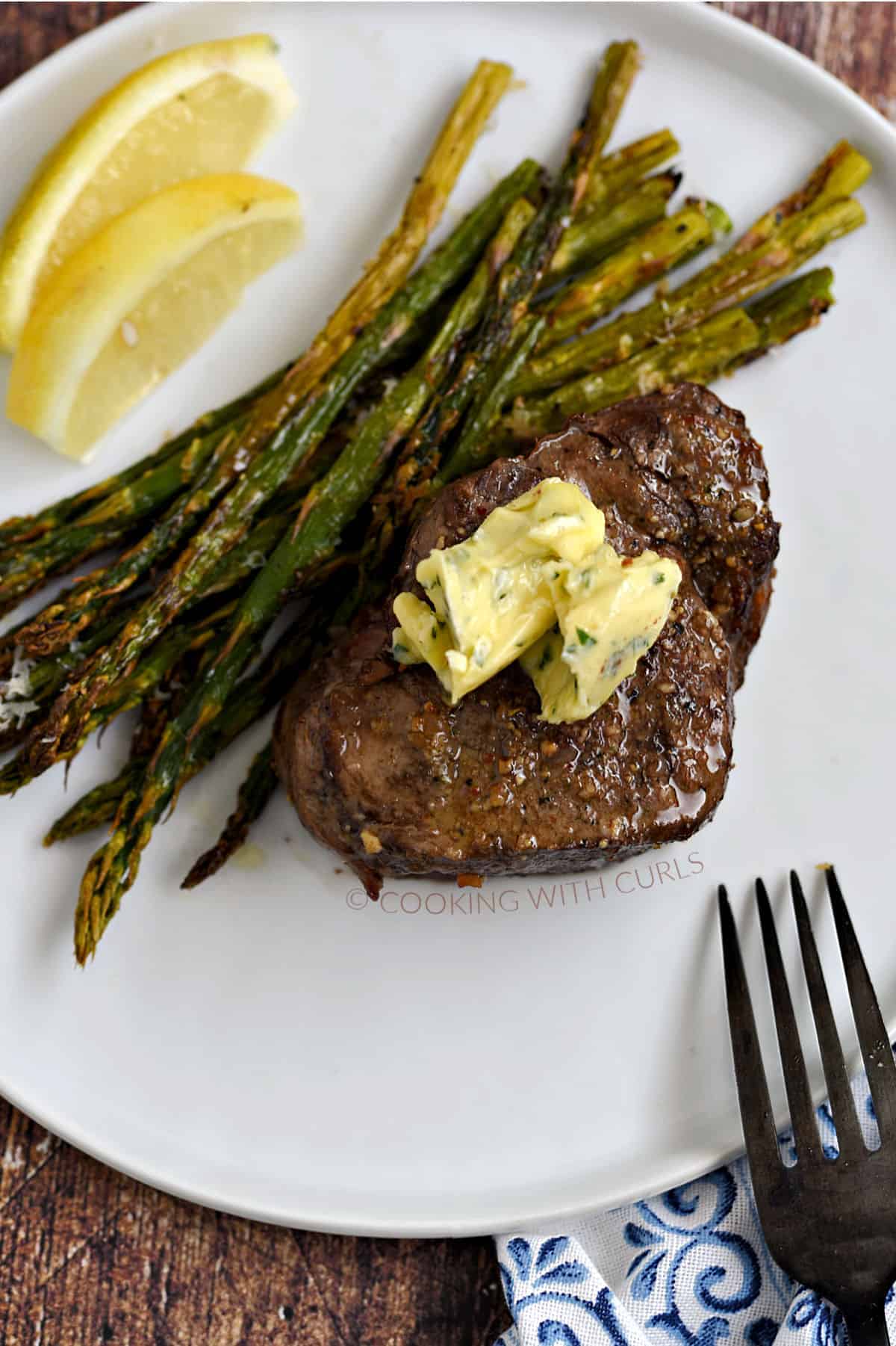 Air Fryer Steak and Asparagus topped with garlic butter. cookingwithcurls.com_