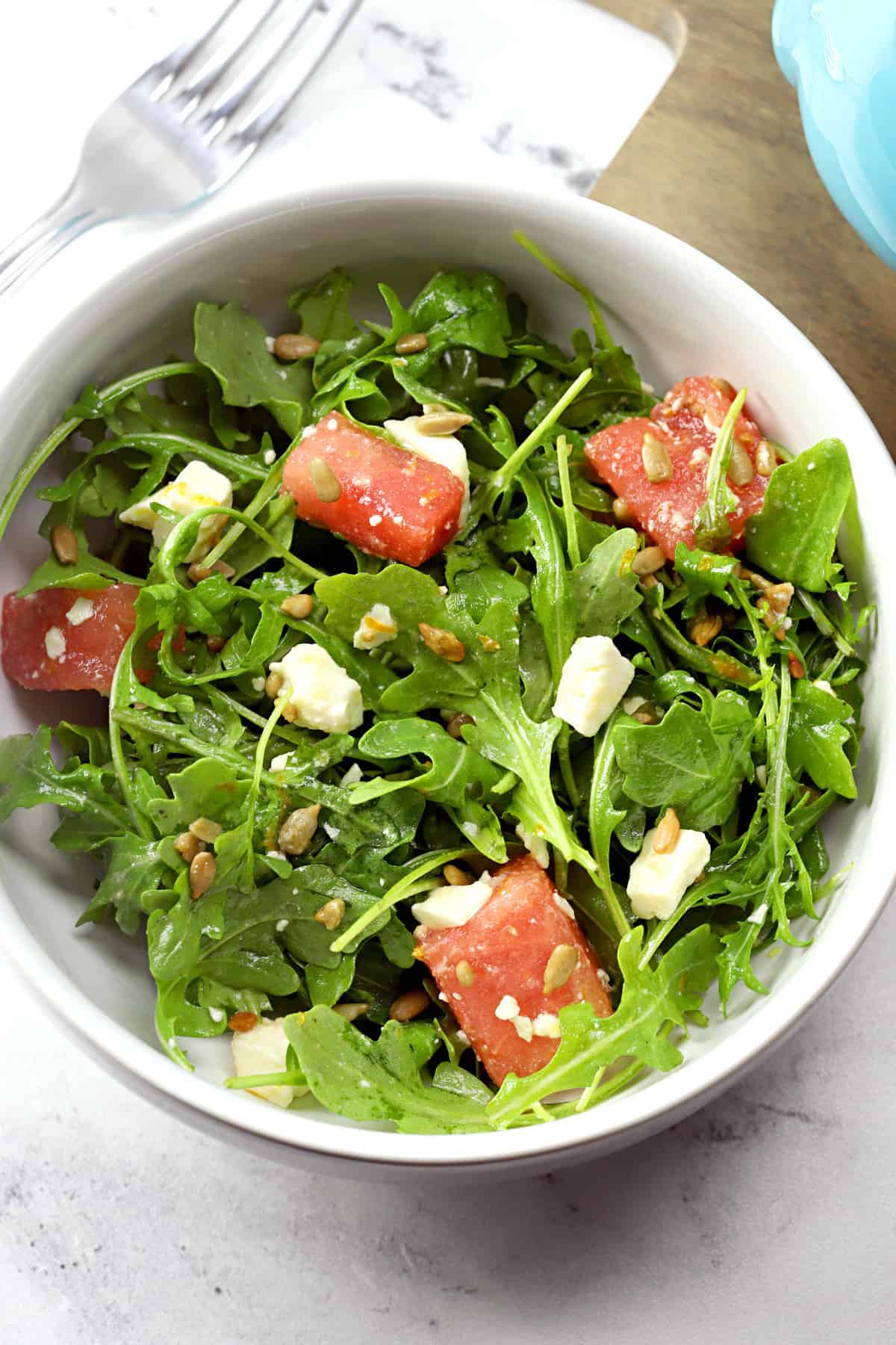 bowl of arugula salad with watermelon