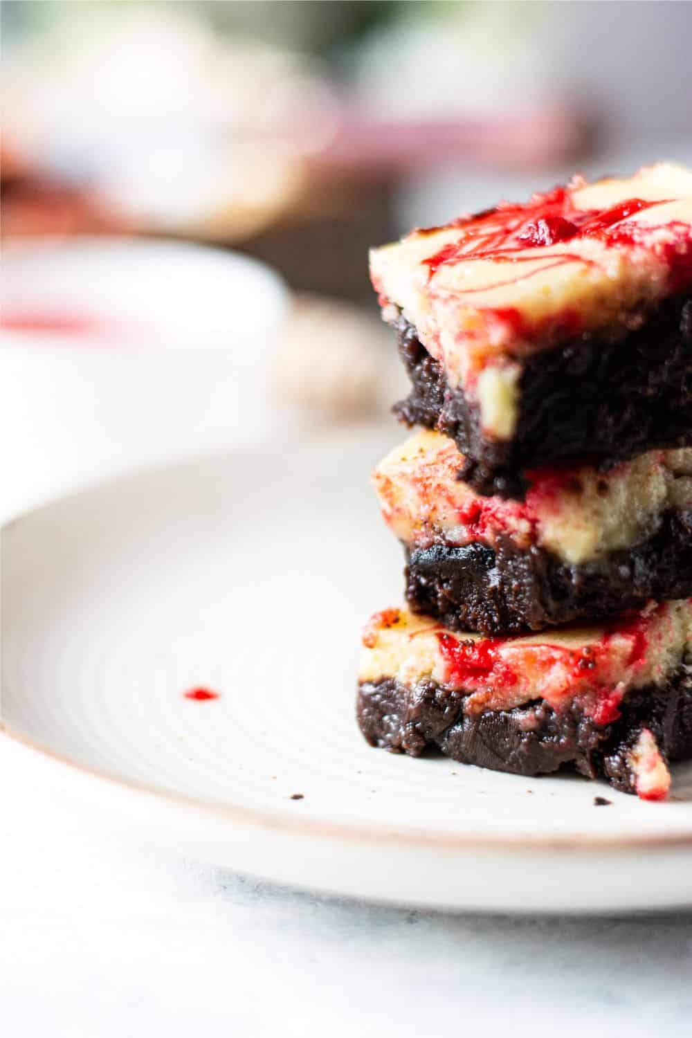 Fudgy cherry cheesecake brownies with swirled cherry topping and rich chocolate chunks